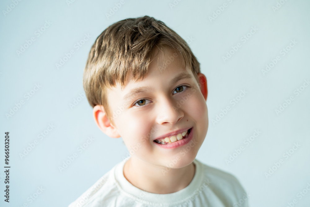 Portrait of 10 year old boy who smiles and shows the fallen cliques. Milk teeth. House. Portrait of 10 year old boy who smiles and shows the fallen cliques. Milk teeth. House.