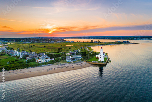 Summer sunset on the Connecticut River, Shoreline, and Long Island Sound in Old Saybrook, CT, with Lynde Lighthouse in the foreground, along with Fenwick, and a colorful summer sunset sky