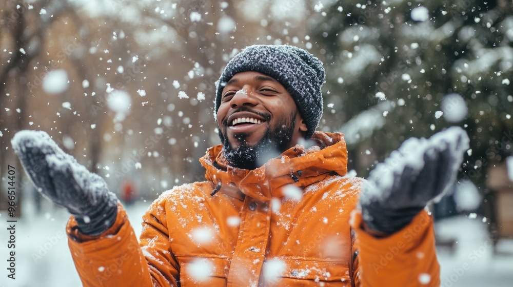 Joyful Man Enjoying Snowfall in Park Wearing Winter Clothes and Smiling Happily Joyful Man Enjoying Snowfall in Park Wearing Winter Clothes and Smiling Happily