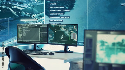 Obraz na plátně Empty military command headquarters with a big display and workstations used for reconnaissance and surveillance monitoring on a world map