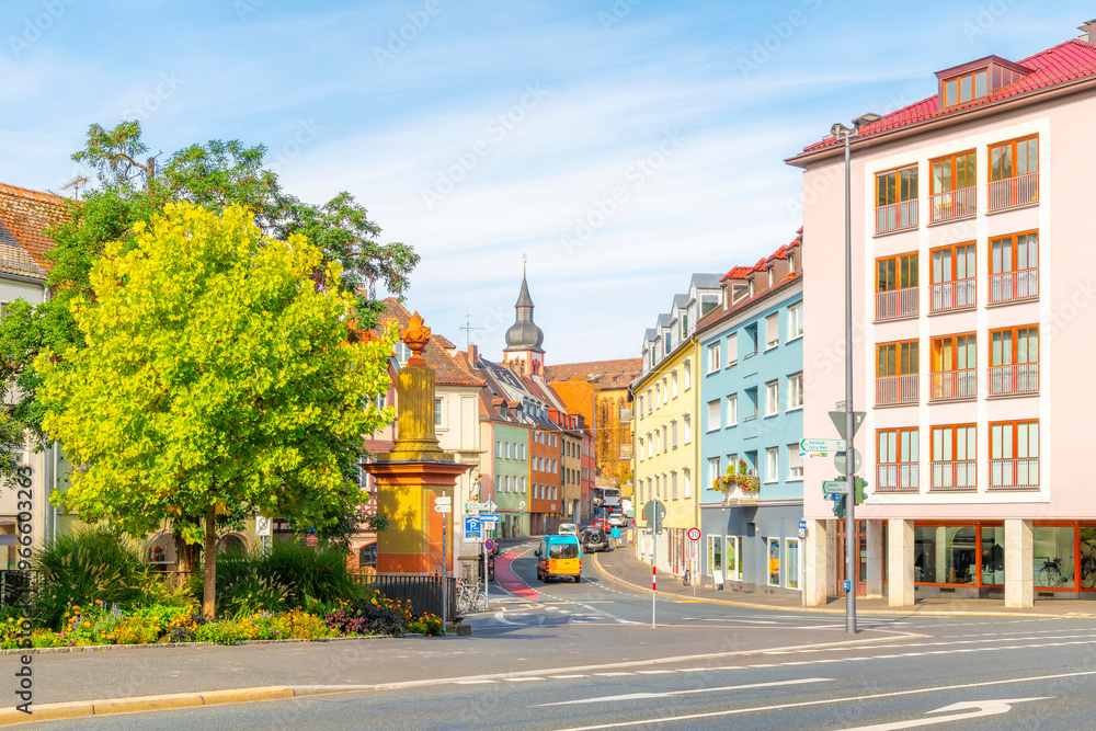 A street of colorful buildings with the dome of the Deutschhauskirche, or Deutschhaus Church, in view along the banks of the Main River in Wurzburg, Germany. A street of colorful buildings with the dome of the Deutschhauskirche, or Deutschhaus Church, in view along the banks of the Main River in Wurzburg, Germany.