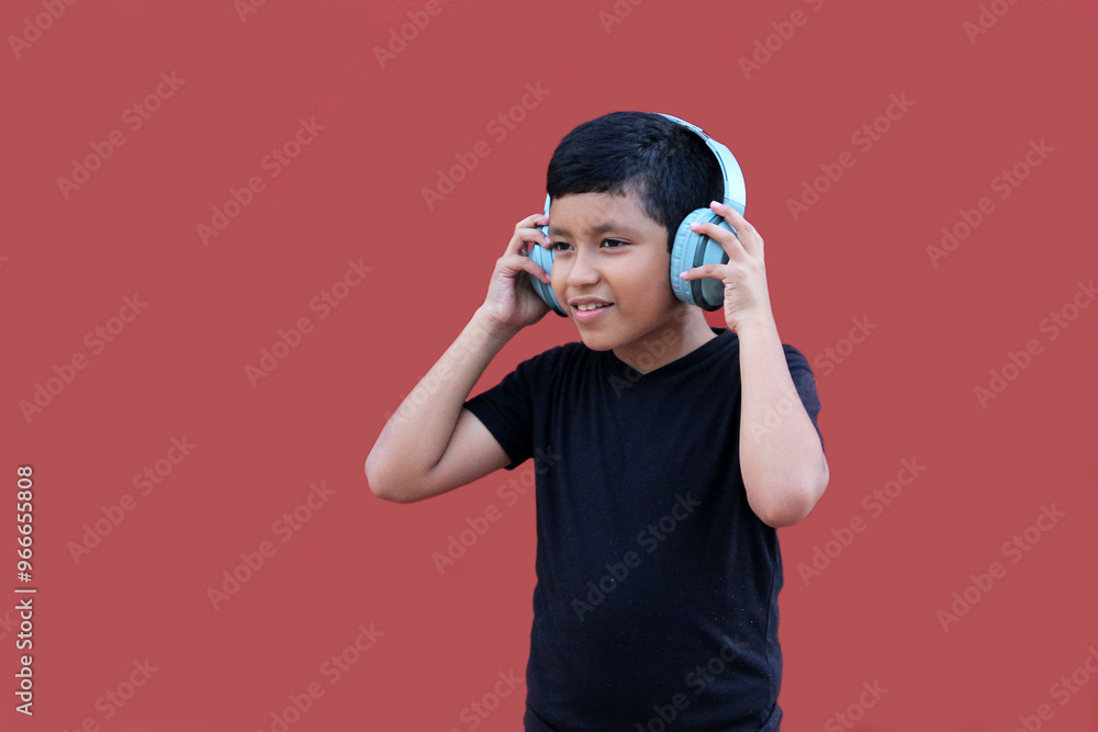 9-year-old brown Latino boy with sound-isolating headphones for autism spectrum disorder, ADHD and sensitivity to loud noises 9-year-old brown Latino boy with sound-isolating headphones for autism spectrum disorder, ADHD and sensitivity to loud noises