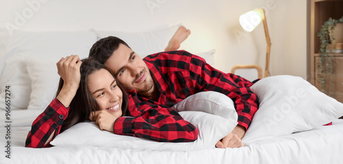 Young couple with pillows l...