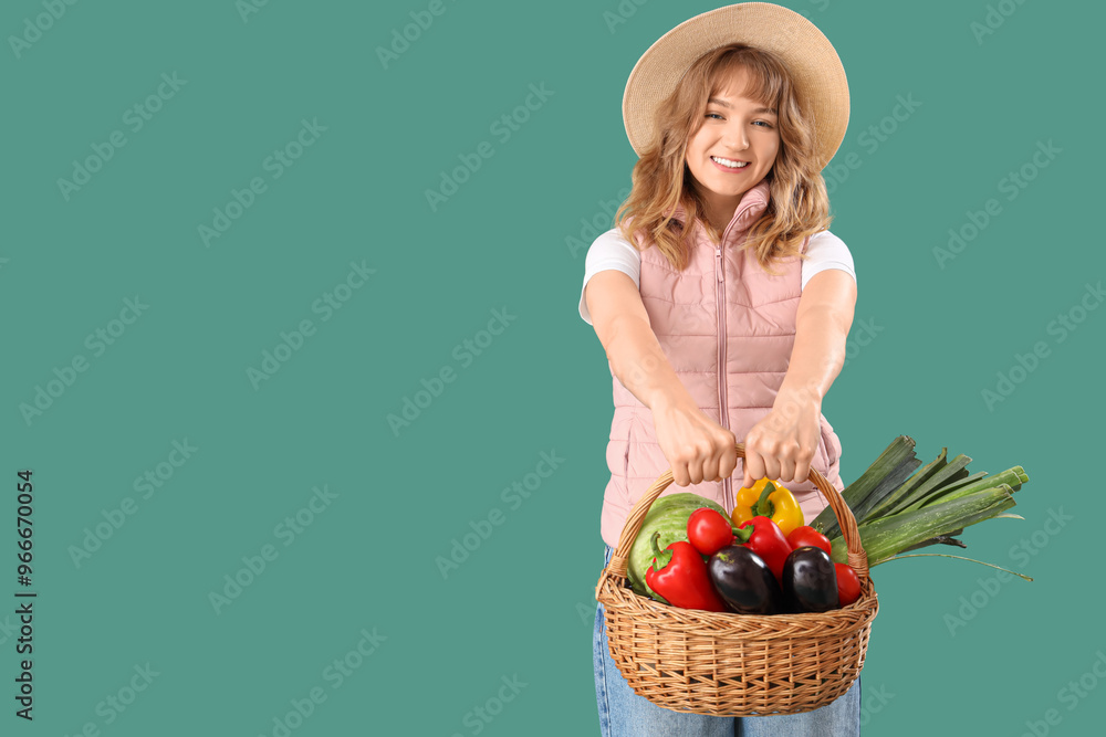 Happy young female farmer with wicker basket full of different ripe vegetables on green background Happy young female farmer with wicker basket full of different ripe vegetables on green background