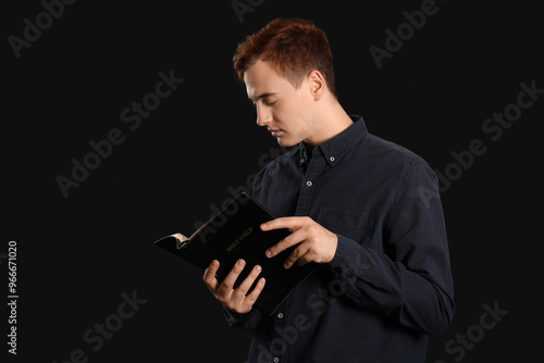 Young redhead man reading B...