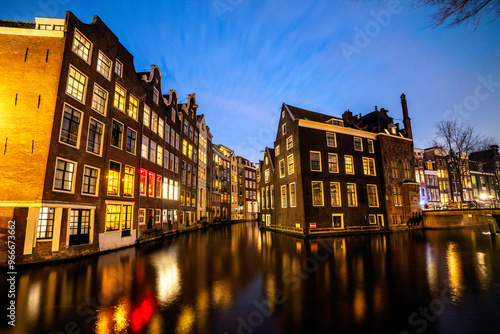 Amsterdam canal Singel with typical dutch houses during twilight, Holland, Netherlands.