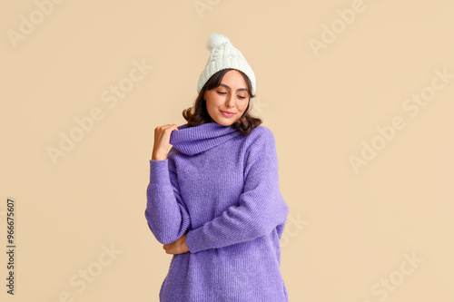 Young woman in warm hat and...