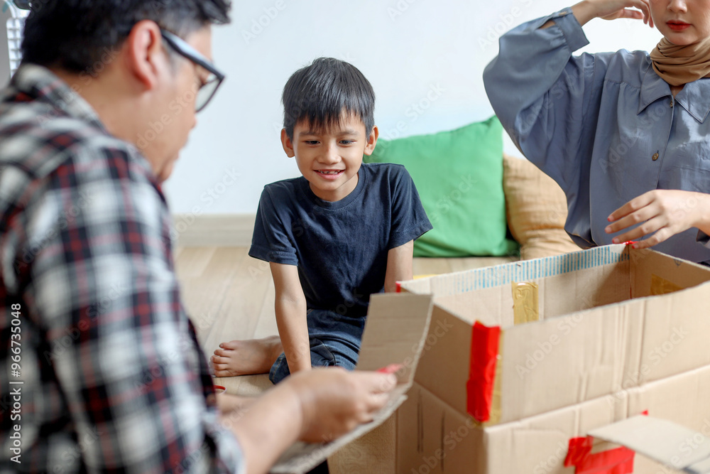 Happy Asian Little Boy Preparing Airplane Made of Cardboard Box With Father And Mother Happy Asian Little Boy Preparing Airplane Made of Cardboard Box With Father And Mother