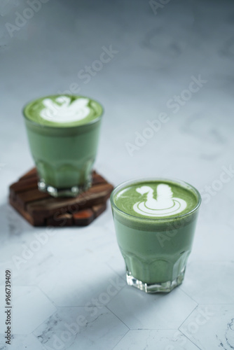 Cup of Matcha Latte With Latte Art on White Marble Table