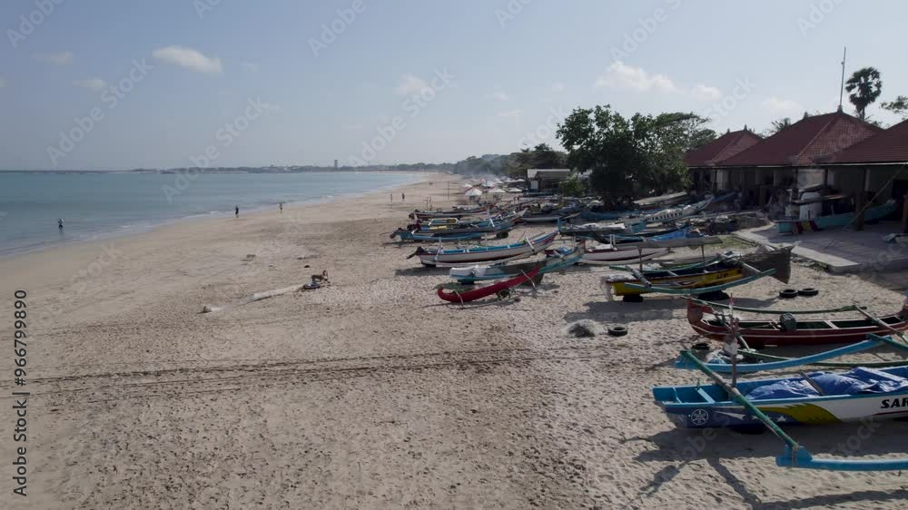 Aerial video on Jimbaran beach at Bali, Denpasar, Indonesia during a sunny day with calming sea waves. Aerial video on Jimbaran beach at Bali, Denpasar, Indonesia during a sunny day with calming sea waves.