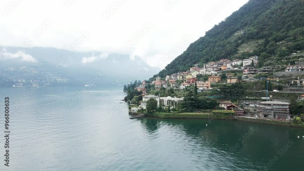 Drone shot circling around a famous villa on the shoreline of Lake Como in Italy. Drone shot circling around a famous villa on the shoreline of Lake Como in Italy.