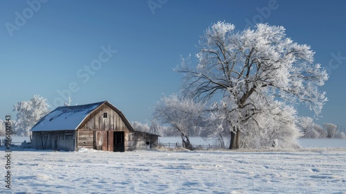 Farm barn in a cold winter landscape with snow and frost
