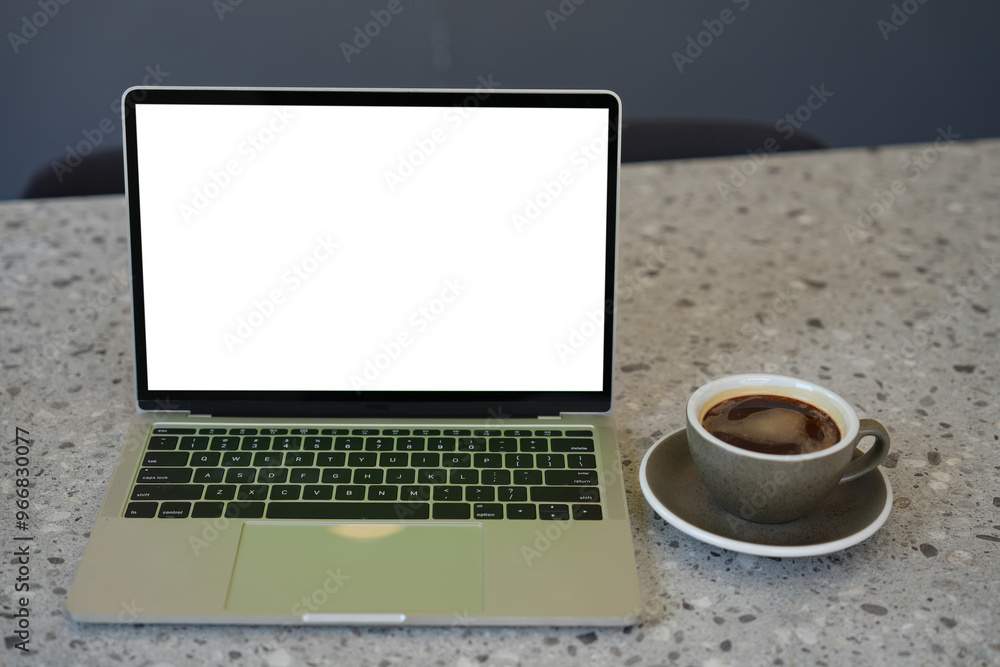 Laptop computer with blank white screen with coffee cup on table. Working business concept. Laptop computer with blank white screen with coffee cup on table. Working business concept.