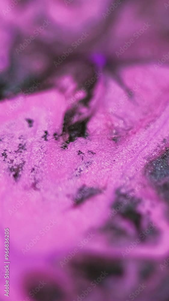 Vertical video. Paint drop. Glitter ink splash. Defocused pink purple black color shimmering texture fluid gloss splatter mix motion abstract art background.