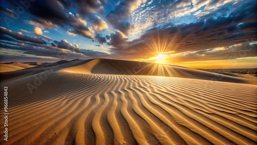 Sand dune at sunset with beam of light on immaculate pattern photo