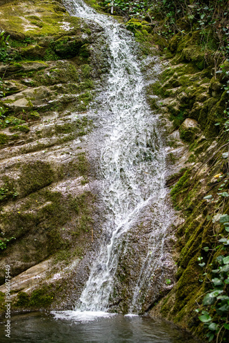 A waterfall is flowing down a rocky cliff