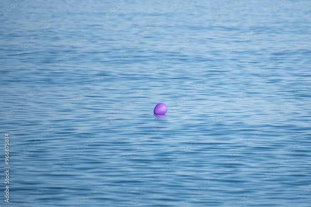 A purple balloon is floating in the ocean A purple balloon is floating in the ocean