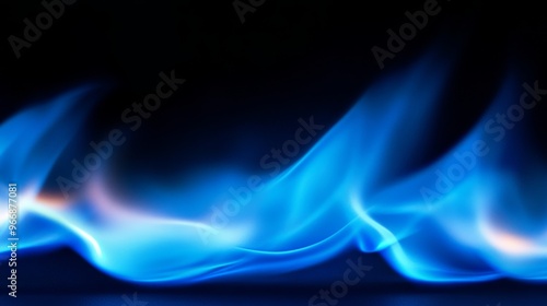 A vivid blue flame dances upward in a closeup captured against a black background, highlighting its soft curves and enchanting flickers of light