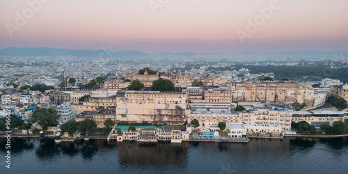 Aerial view city palace in Udaipur during sunrise, known for its beautiful lakes, palaces, and historical significance. The city was founded in 1559. photo