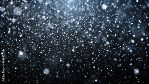 Snow falling against black background