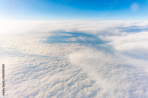 View from the airplane window at a beautiful cloudy sky and the airplane wing