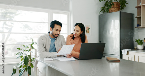Valokuva Kitchen, couple and conversation with document for finance, track expenses and laptop for budget goal