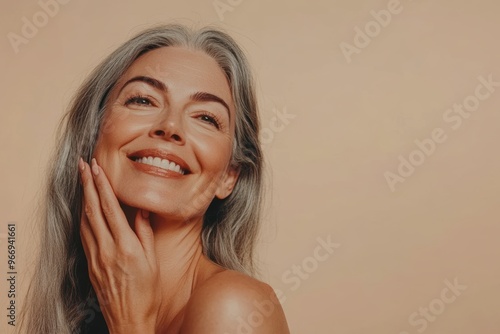 Portrait of a joyful mature woman with long gray hair and a radiant smile, exuding confidence and positivity on a soft neutral background. Generated AI photo