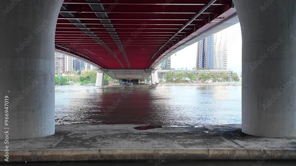 Ba Son cable bridge at Ho Chi Minh city, with big bridge piers, cargo boat cross under modern infrastructure on Sai Gon river Ba Son cable bridge at Ho Chi Minh city, with big bridge piers, cargo boat cross under modern infrastructure on Sai Gon river
