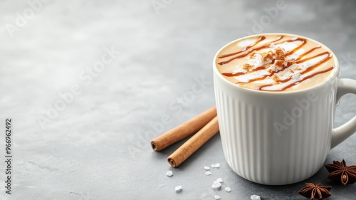 High-angle shot of creamy caramel macchiato with intricate caramel drizzle, marble countertop, and cinnamon stick. photo