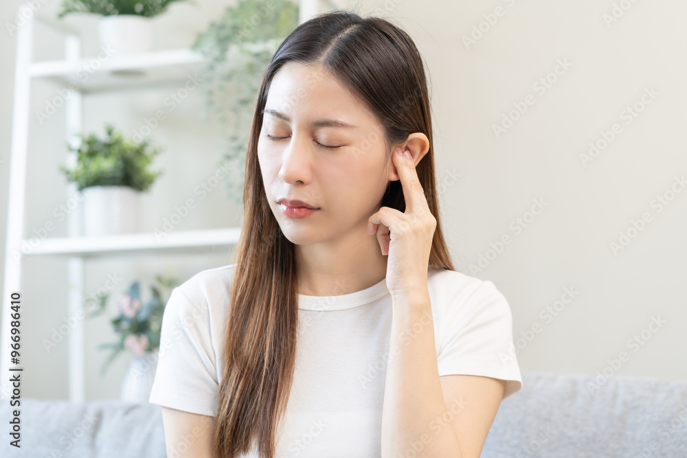 Tinnitus concept, sick asian young woman, girl have ear pain or earache, hand touch plug ear, suffering painful otitis from loud of noisy sound, inflammation. Health care nerve deaf eardrum disease. Tinnitus concept, sick asian young woman, girl have ear pain or earache, hand touch plug ear, suffering painful otitis from loud of noisy sound, inflammation. Health care nerve deaf eardrum disease.