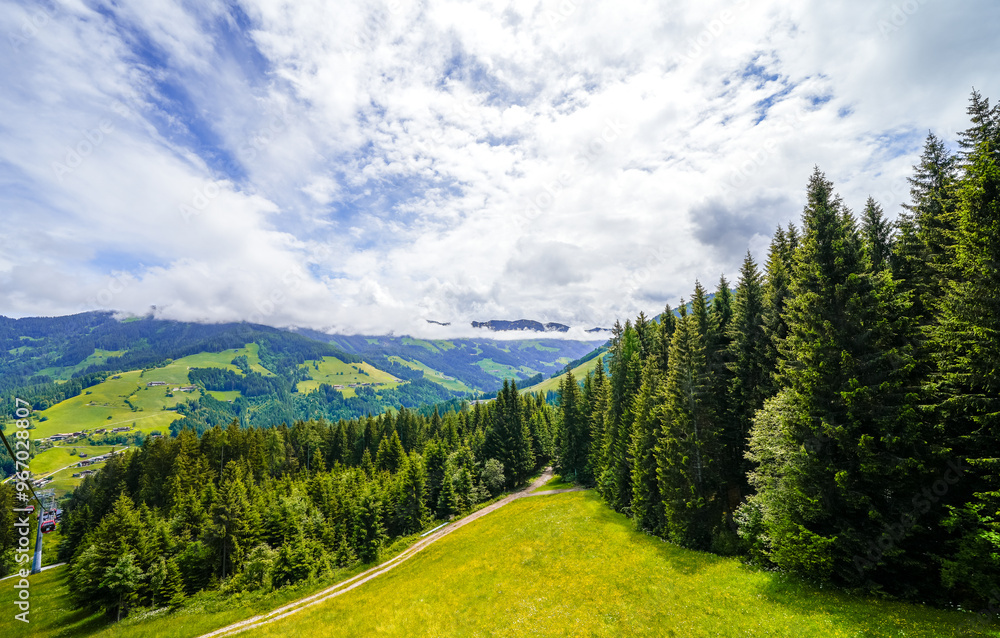 Fototapeta premium View from Schatzberg of the surrounding landscape. Idyllic nature in Wildschönau in the Kufstein district in Austria. Mountain landscape in the Kitzbühel Alps in Tyrol. 
