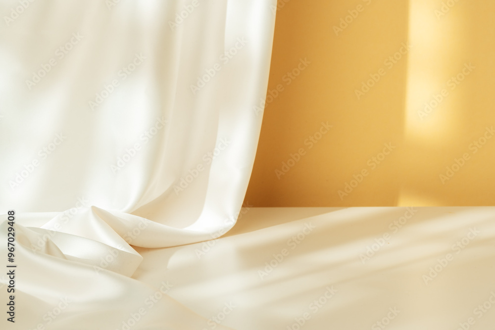 Soft White Fabric Draped Elegantly Against a Warm Yellow Wall in Natural Light Soft White Fabric Draped Elegantly Against a Warm Yellow Wall in Natural Light