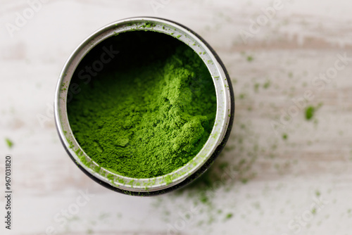 Closeup of fresh matcha powder on white wooden background. Selective focus.
