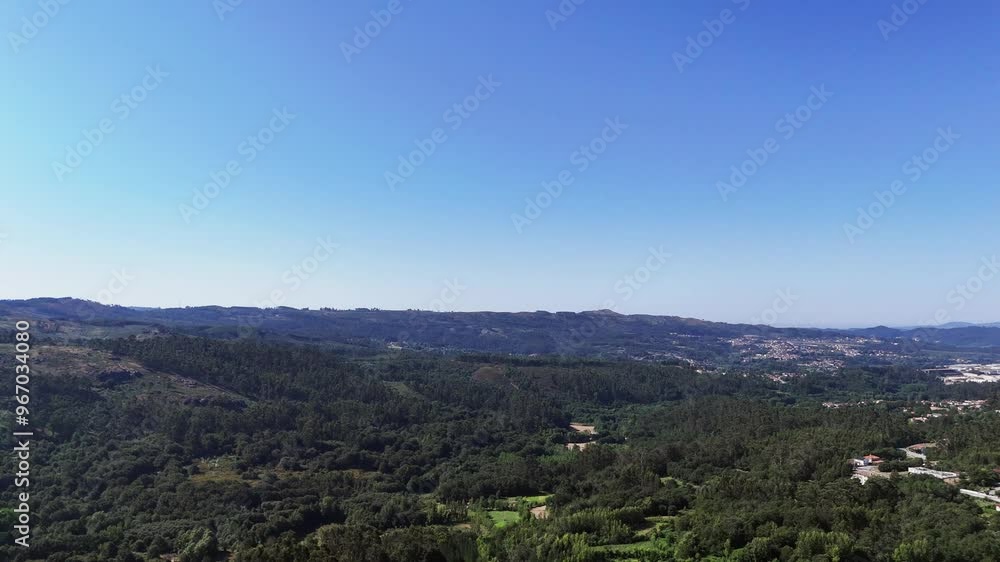 Aerial - Expansive view of northern Portugal's rolling green hills under clear blue sky Aerial - Expansive view of northern Portugal's rolling green hills under clear blue sky