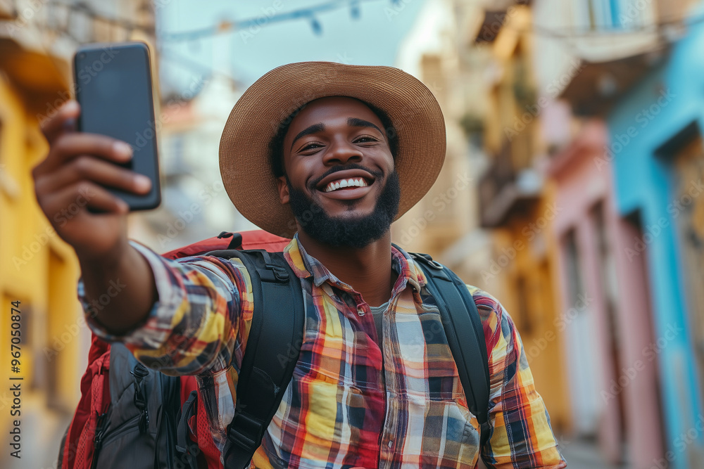 man with a beard and sunglasses is smiling and taking a selfie. He is wearing a brown hat and a backpack man with a beard and sunglasses is smiling and taking a selfie. He is wearing a brown hat and a backpack