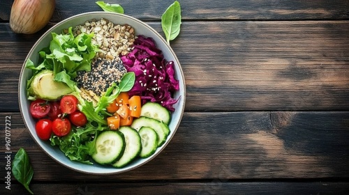 Overhead photo of a healthy breakfast bowl with colorful vegetables, seeds, t, arranged beautifully on a wooden table