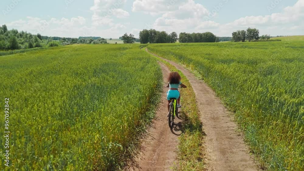 Biking through green fields on a sunny day in the countryside Biking through green fields on a sunny day in the countryside