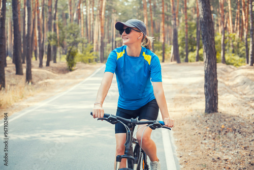 woman cyclist rides in the forest on a bike.