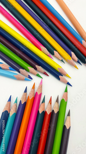 Colorful sharpened pencils are lined up on the table.