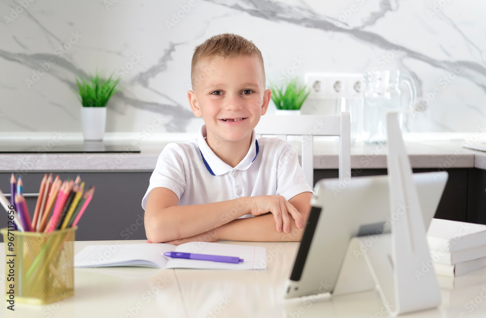 School boy studying at home, doing homework with laptop. Distance online learning. Back to school. One more question to be answered. School boy studying at home, doing homework with laptop. Distance online learning. Back to school. One more question to be answered.