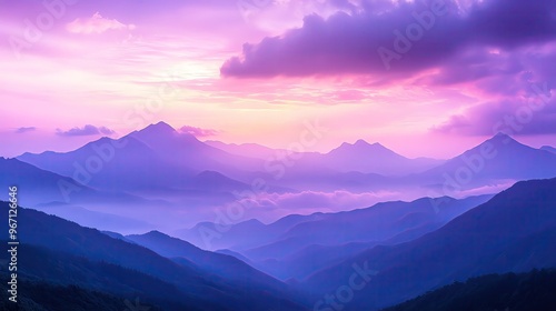 Breathtaking mountain landscape at sunset with vibrant purple skies and misty valleys, perfect for nature and travel themes.