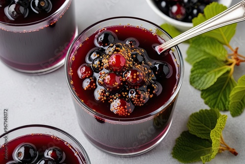 Vibrant Blackcurrant Compote with Sparkling Pearls in Zesty Syrup on Clean Background