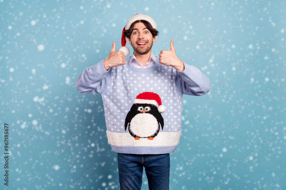 Photo of impressed pretty gentleman wear new year sweater smiling showing thumbs up isolated blue color background Photo of impressed pretty gentleman wear new year sweater smiling showing thumbs up isolated blue color background