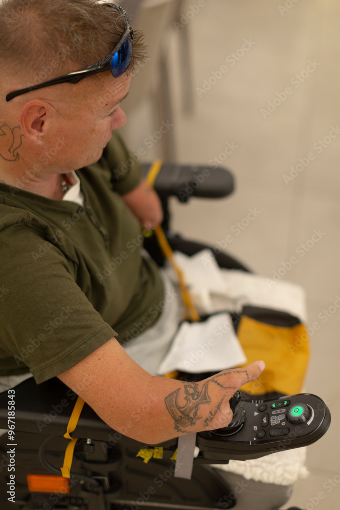 An individual utilizing an adaptive control device as they remain seated comfortably in their wheelchair An individual utilizing an adaptive control device as they remain seated comfortably in their wheelchair