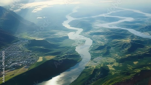Wallpaper Mural Stunning aerial view of a river winding through lush green mountains, taken from a private jet. The landscape showcases the beauty and tranquility of nature from a unique perspective Torontodigital.ca