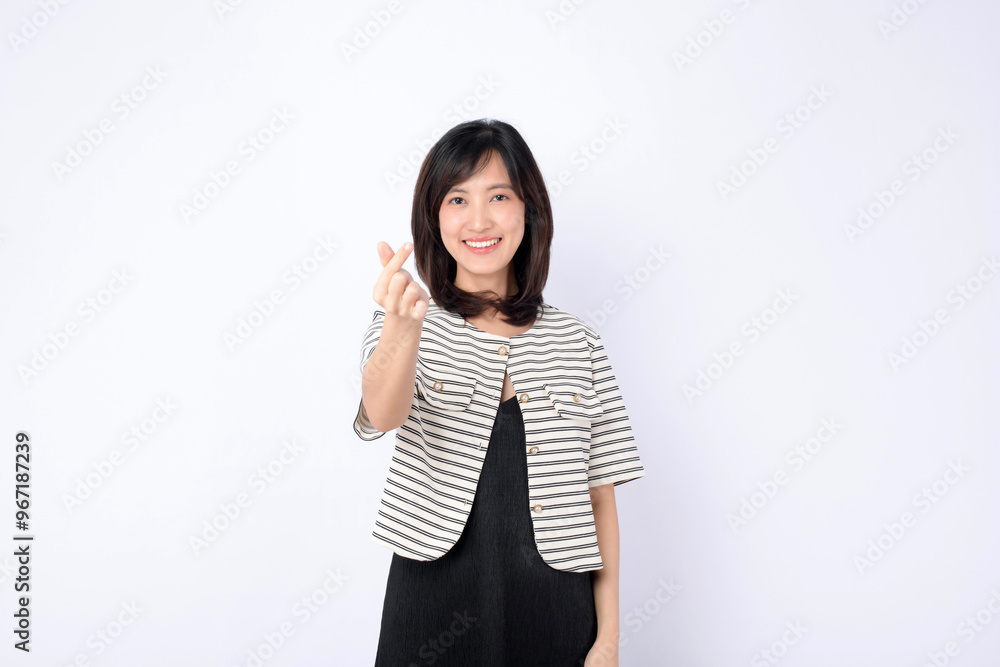 An Asian woman is making a mini heart gesture on a white background. An Asian woman is making a mini heart gesture on a white background.