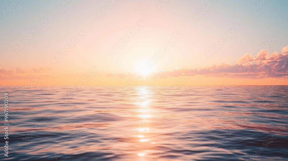 Fototapeta premium The sun is setting over the ocean, casting a warm glow on the water