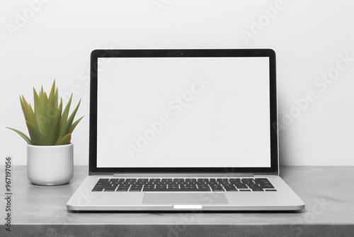 A modern office computer table featuring a blank laptop screen mockup, template for your text, perfect for design presentations.