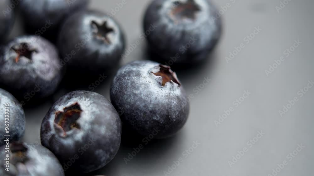 Fresh blueberries being carefully selected for a summer dessert with rich color and texture on a black luxury surface. Rotation Fresh blueberries being carefully selected for a summer dessert with rich color and texture on a black luxury surface. Rotation