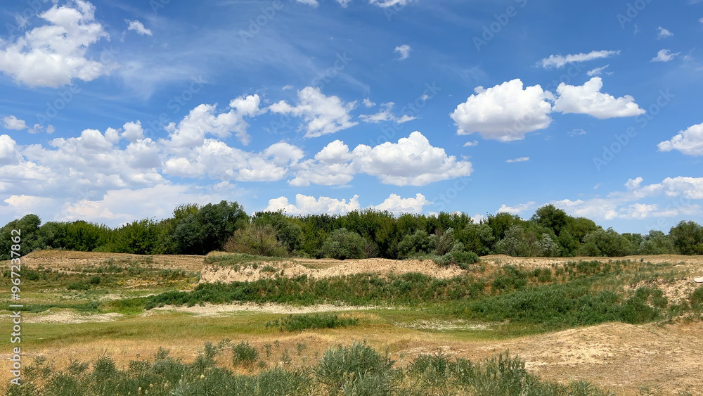 Obraz premium Picturesque landscape blue sky with clouds and dense green vegetation